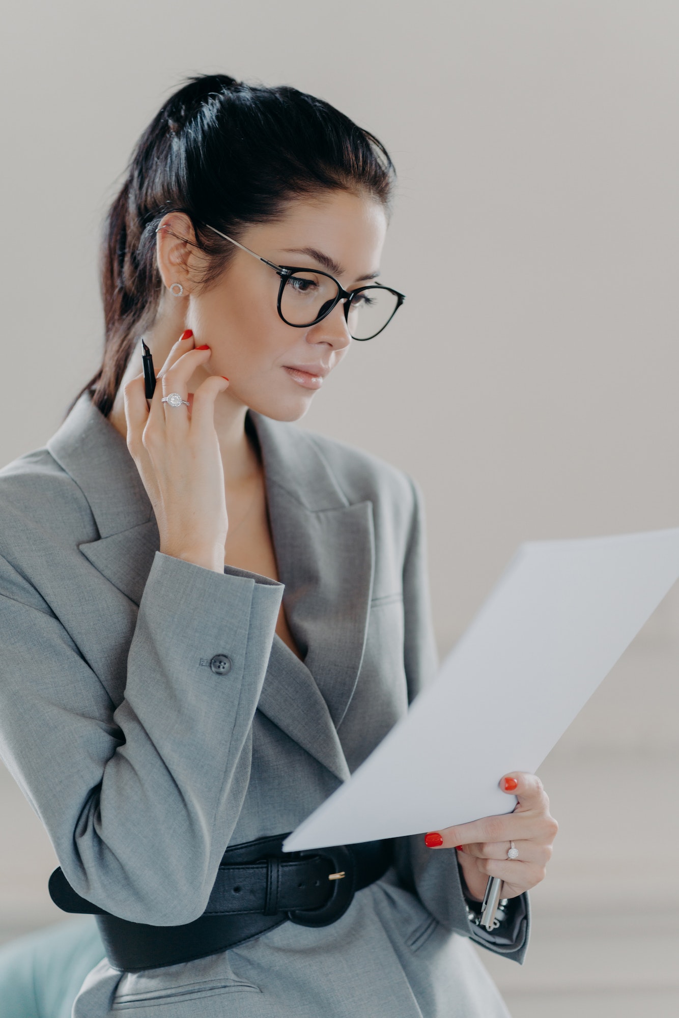 Successful female executive manager looks through paper documents, analyzes data